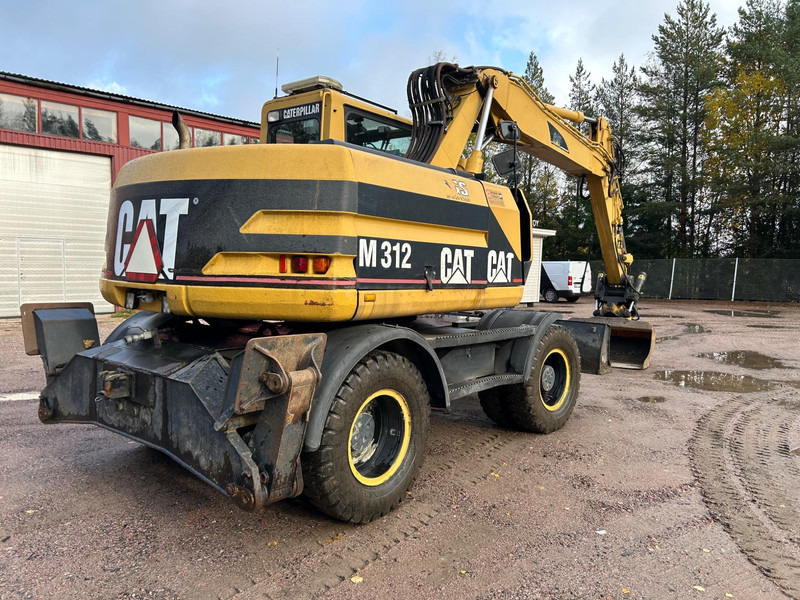 Grävmaskin på däck Caterpillar M312 Engcon EC20 tiltrotator