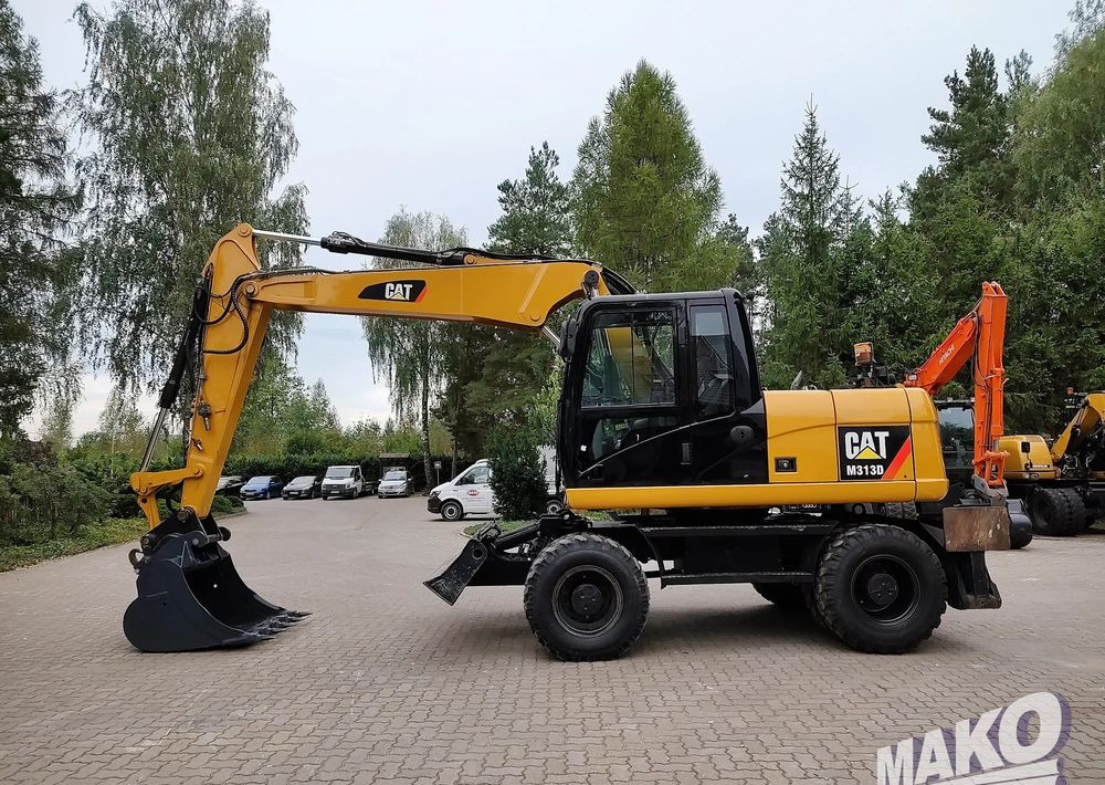Caterpillar M313D - Grävmaskin på däck: bild 1 Caterpillar M313D - Grävmaskin på däck: bild 1
