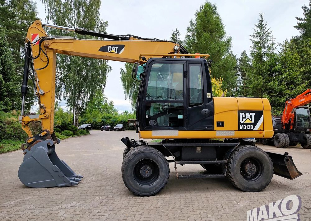 Caterpillar M313D - Grävmaskin på däck: bild 1 Caterpillar M313D - Grävmaskin på däck: bild 1