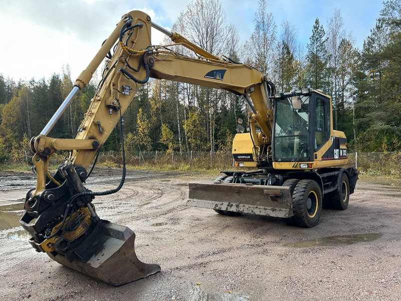 Caterpillar M312 Engcon EC20 tiltrotator - Grävmaskin på däck: bild 1 Caterpillar M312 Engcon EC20 tiltrotator - Grävmaskin på däck: bild 1