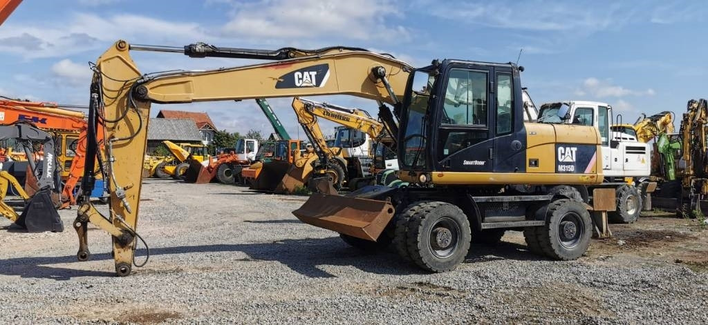 CAT M 315 D - Grävmaskin på däck: bild 1 CAT M 315 D - Grävmaskin på däck: bild 1