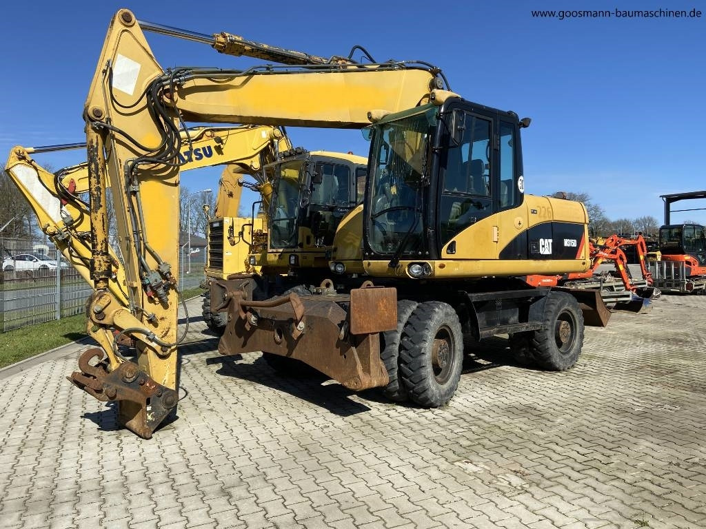 CAT M 315D - Grävmaskin på däck: bild 1 CAT M 315D - Grävmaskin på däck: bild 1